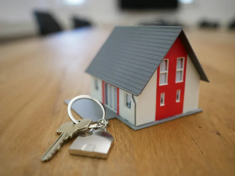 House keys with a small model home on a table