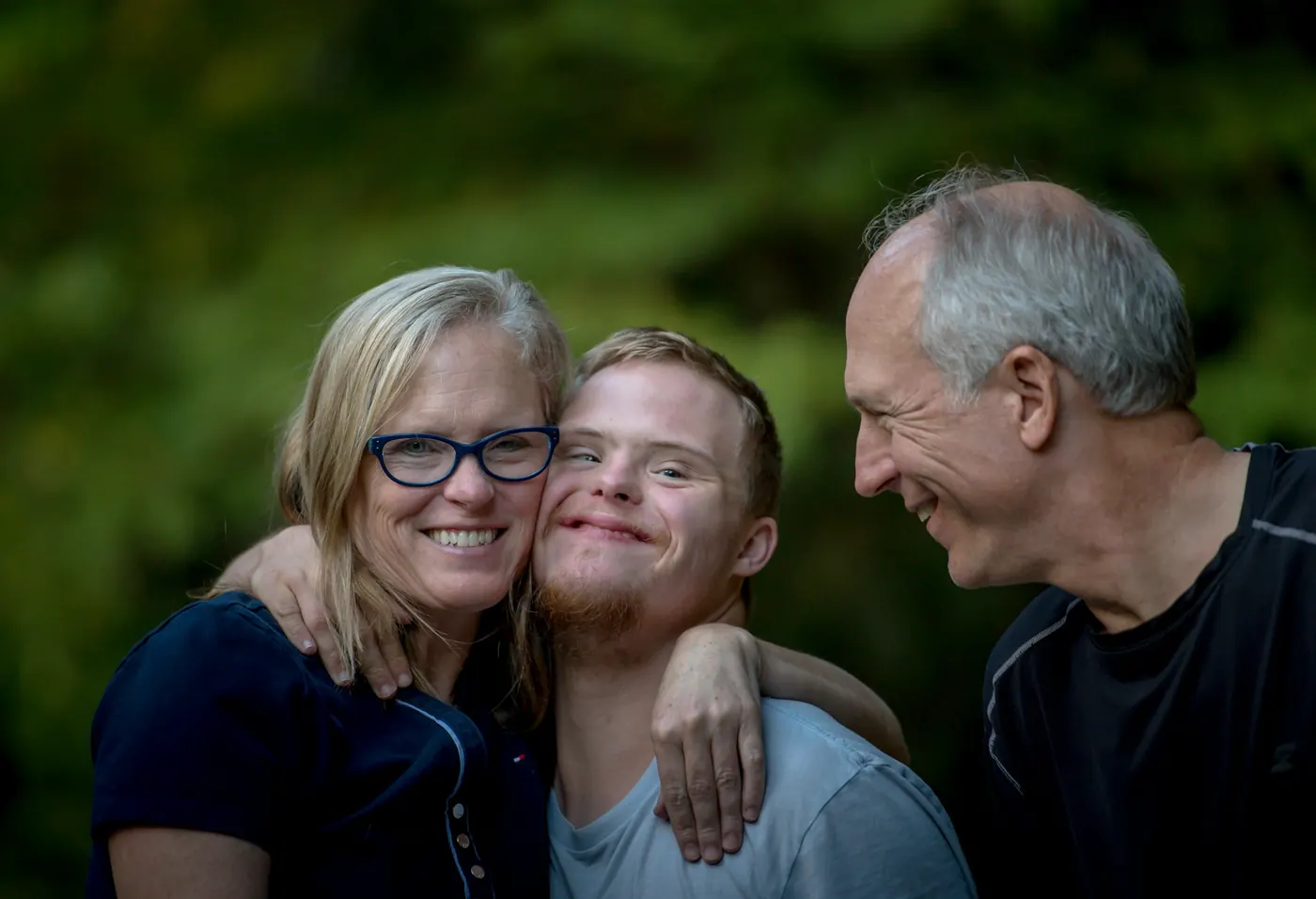 Senior couple embracing their adult son