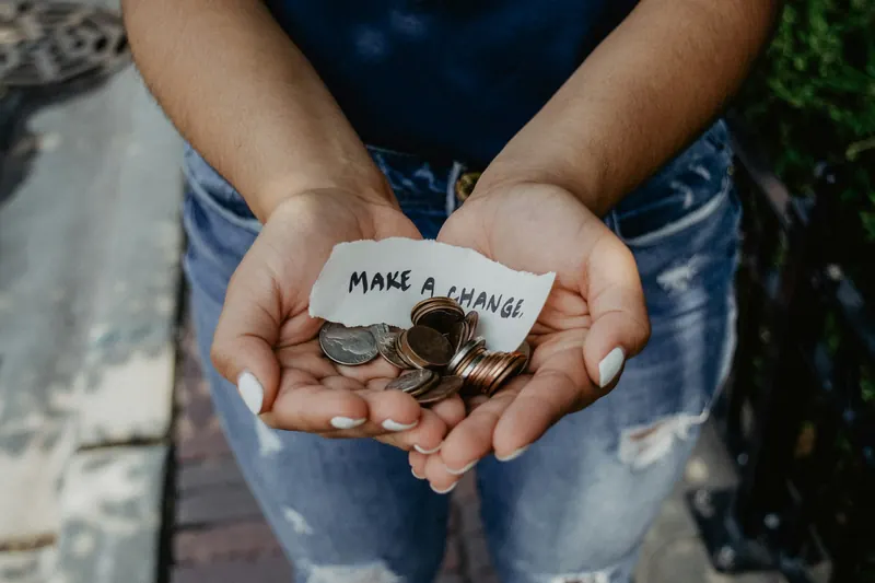 Open hands holding coins