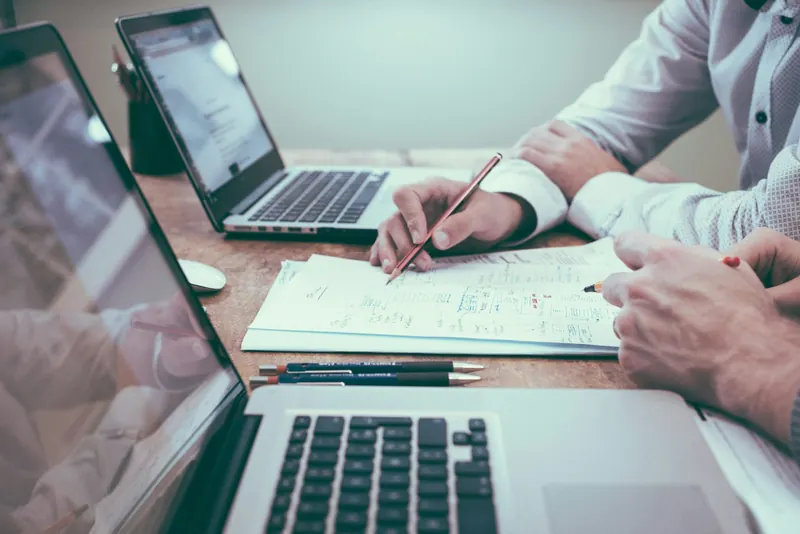 Reviewing plans and documents across a desk