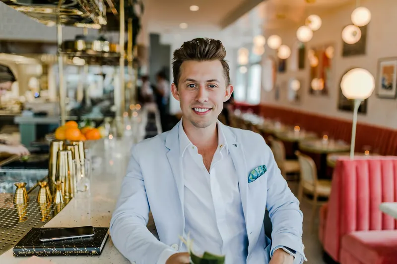 A small business owner standing proudly in his restaurant